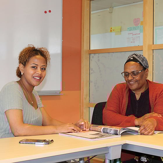 Två kvinnliga kursdeltagare studerar tillsammans